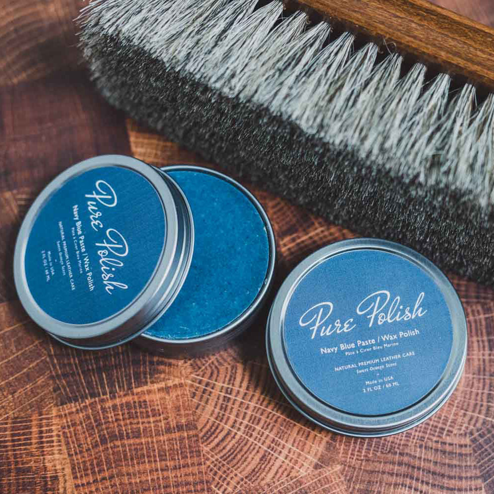 Navy Blue Shoe Polish Paste Wax open tin next to a horsehair brush