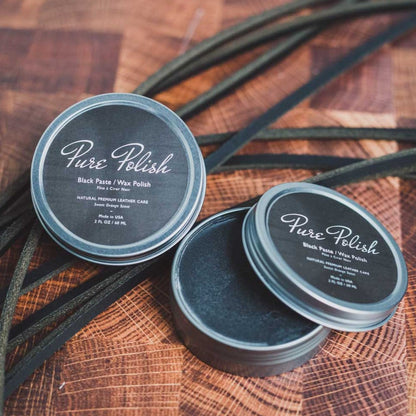 Pure Polish Black Paste/Wax Polish on a wooden cutting board with black leather straps