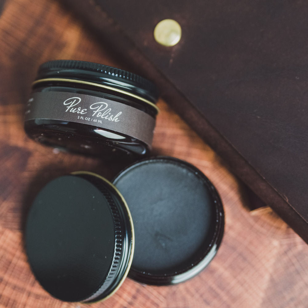 Dark Brown Leather Shoe Cream Polish open next to a leather folio