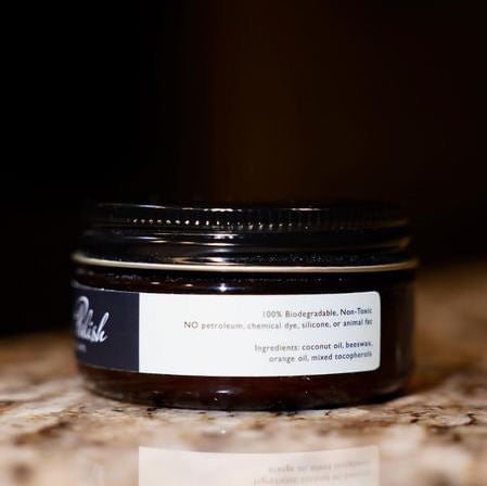 Shell Cordovan Cream by Pure Polish side label with ingredients of the product in focus, sitting on a marble table